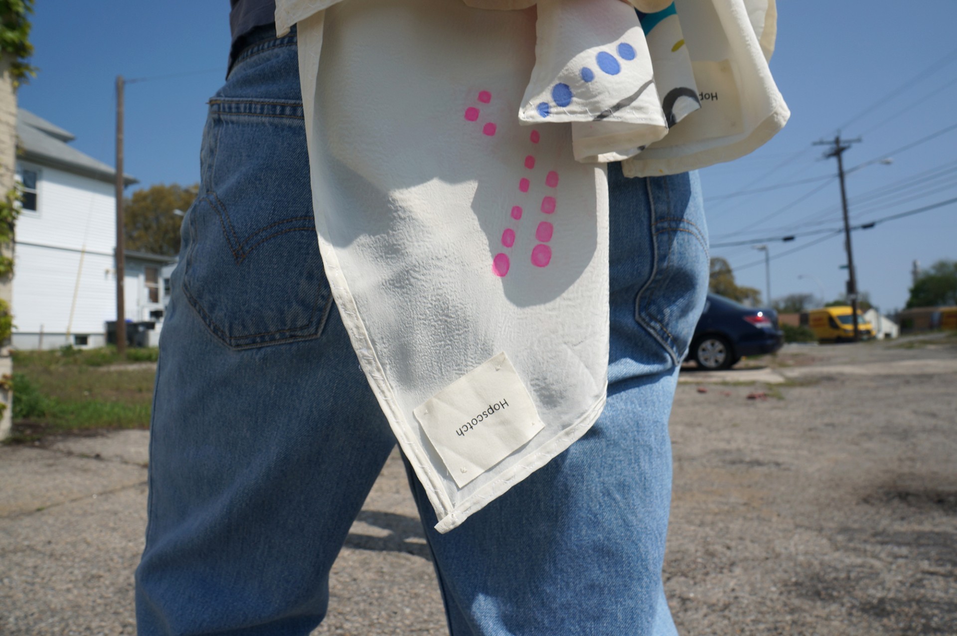 Model wearing scarf. Hopscotch tag highlighted. 