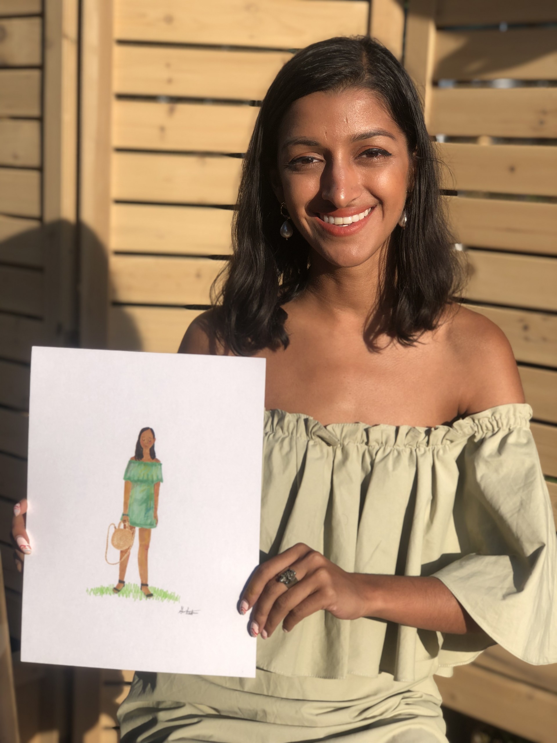 Model holding portrait of herself