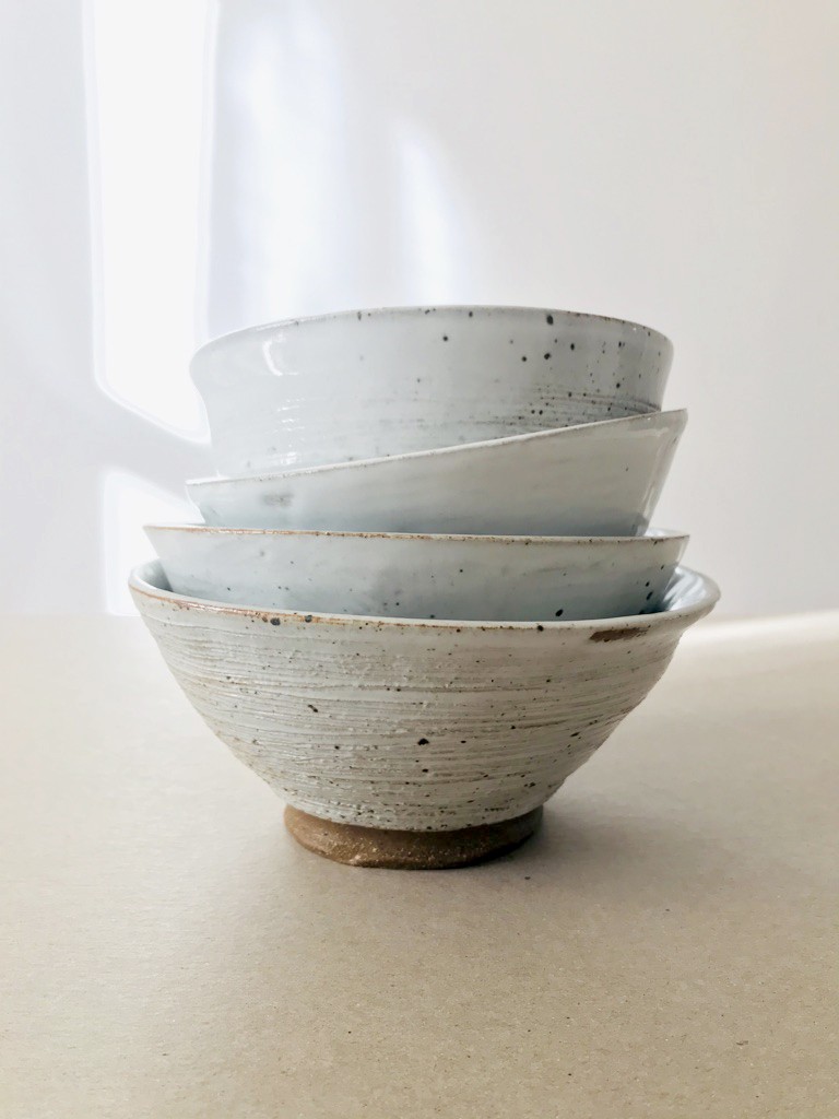 Pile of stoneware white bowls