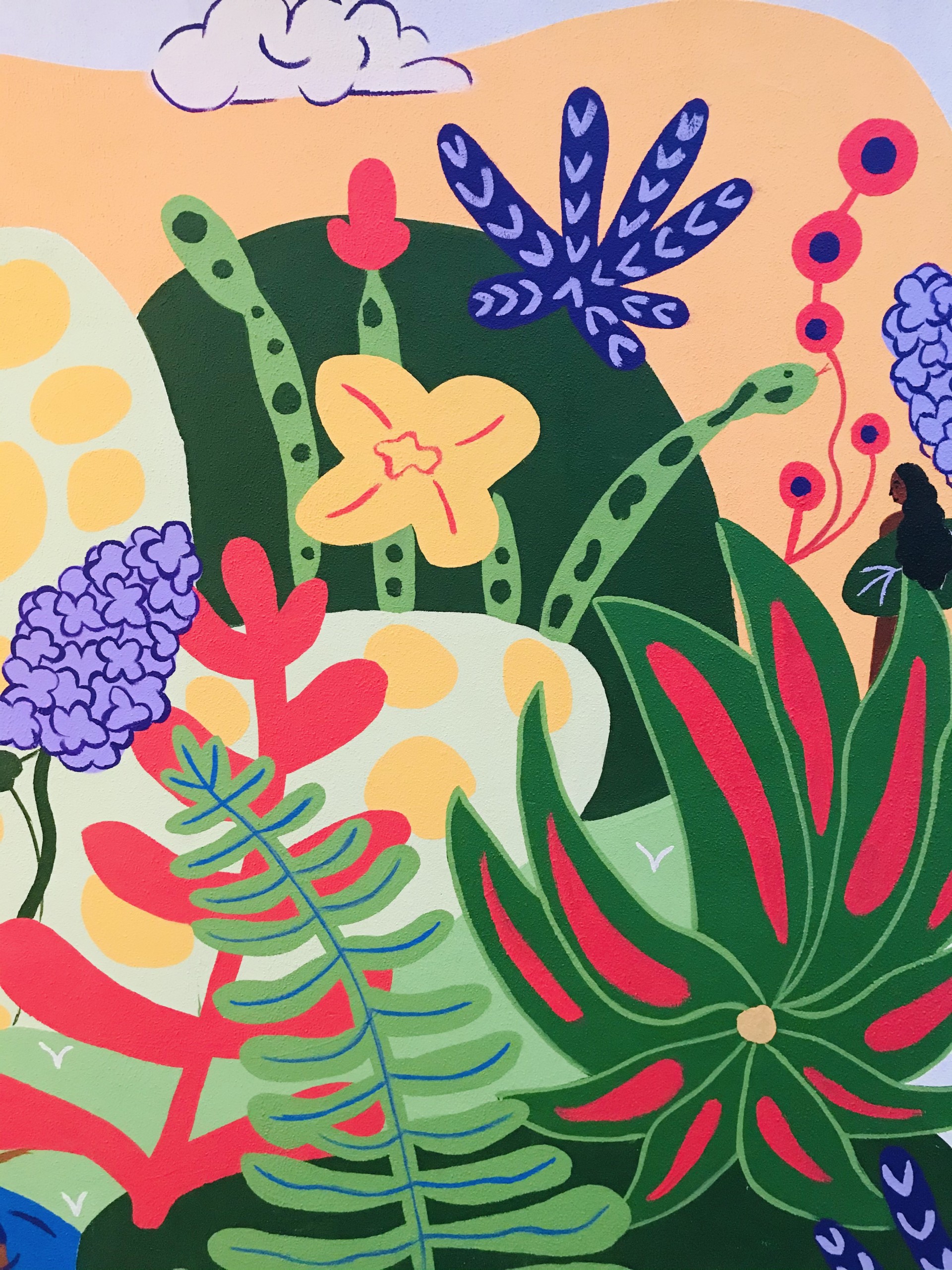 Detail of brightly painted plants, animals and female figure.